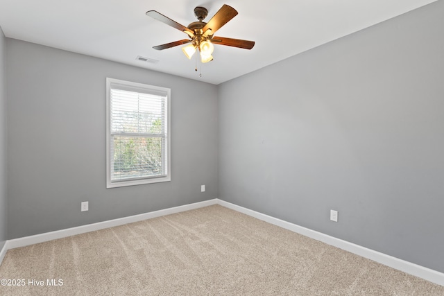 empty room with ceiling fan and carpet