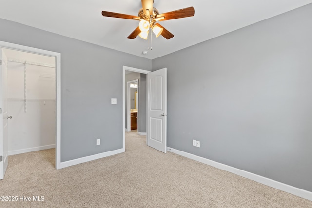 unfurnished bedroom with ceiling fan, light colored carpet, and a closet