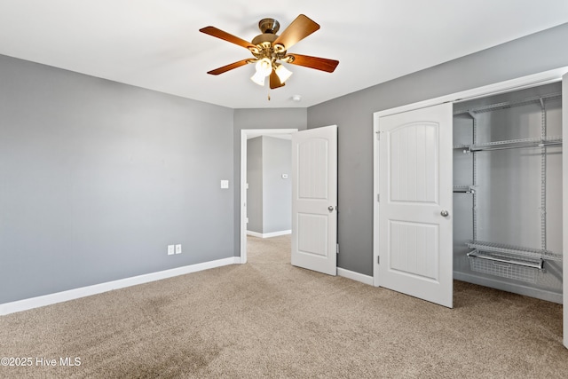 unfurnished bedroom with ceiling fan, carpet floors, and a closet