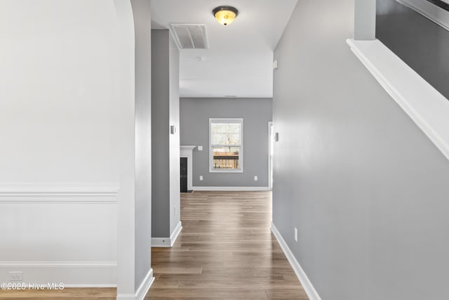 hallway with hardwood / wood-style flooring