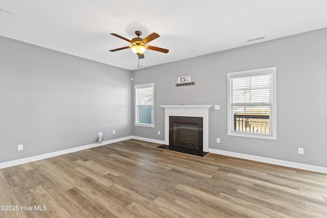 unfurnished living room featuring light hardwood / wood-style flooring and ceiling fan