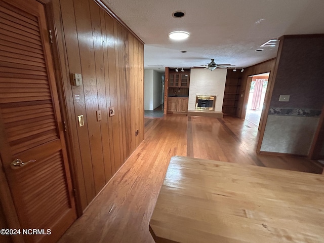 hall featuring wooden walls and light hardwood / wood-style floors