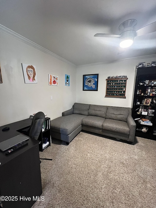 carpeted living area featuring ornamental molding and a ceiling fan