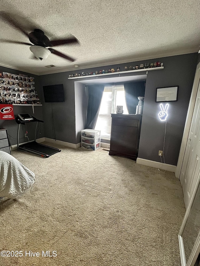 carpeted bedroom with visible vents, ceiling fan, a textured ceiling, and baseboards