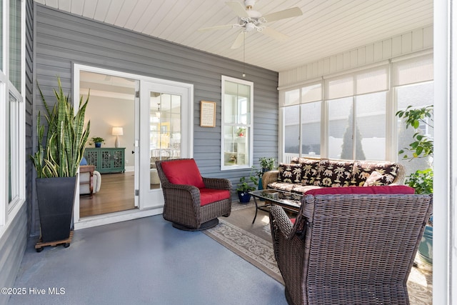 sunroom featuring a ceiling fan