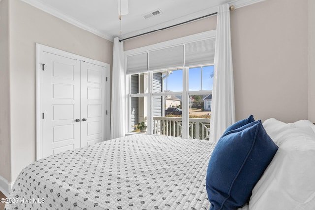 bedroom with ornamental molding, access to outside, a closet, and visible vents