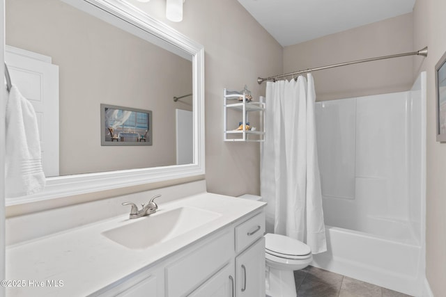 full bath with toilet, shower / bath combo with shower curtain, vanity, and tile patterned floors