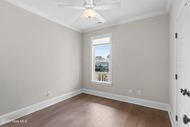 spare room with a ceiling fan, crown molding, baseboards, and wood finished floors