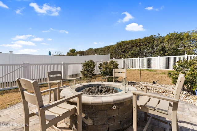 view of patio featuring a fire pit and a fenced backyard