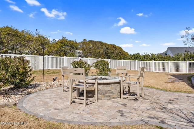 view of patio featuring an outdoor fire pit and fence