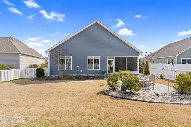 back of property featuring a yard, a patio area, a fenced backyard, and a sunroom