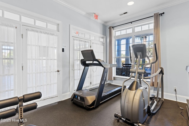 exercise room featuring visible vents, crown molding, and baseboards