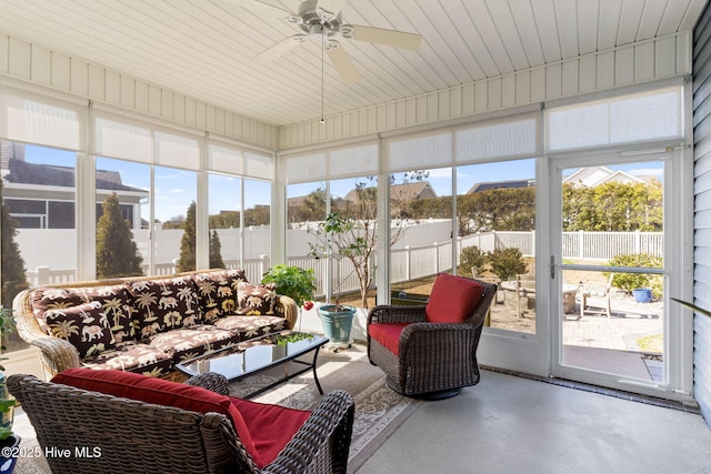 sunroom featuring ceiling fan