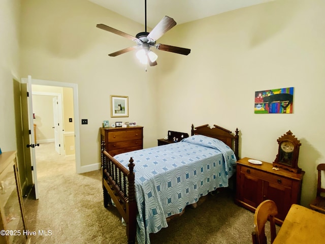 bedroom featuring ceiling fan, high vaulted ceiling, and light carpet