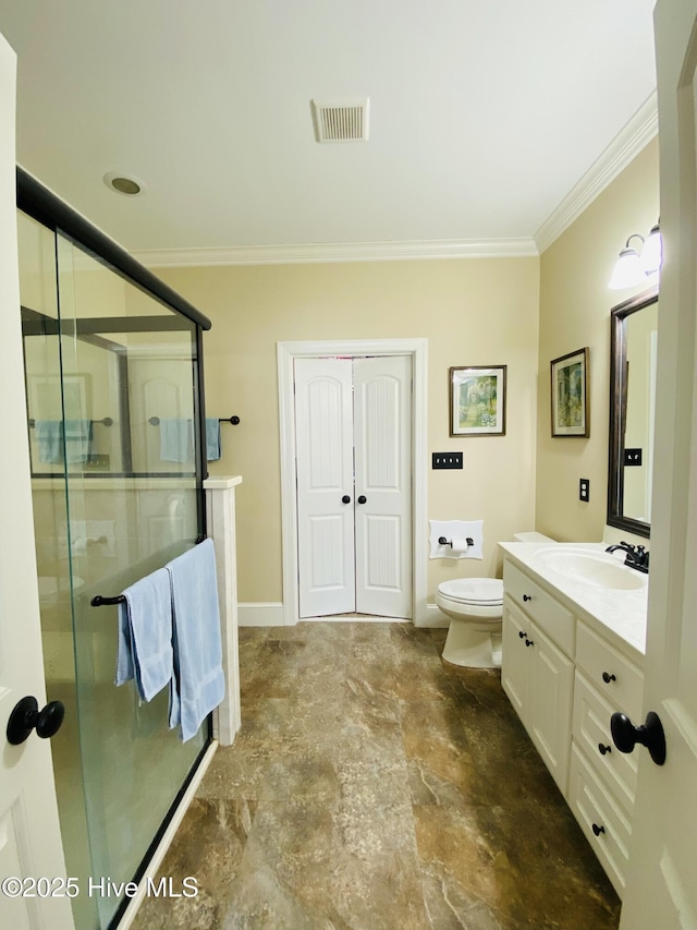 bathroom with crown molding, vanity, toilet, and a shower with door