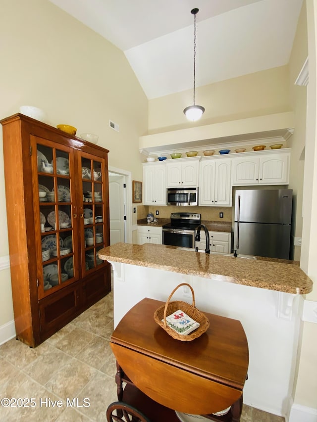 kitchen with stainless steel appliances, white cabinetry, sink, and pendant lighting