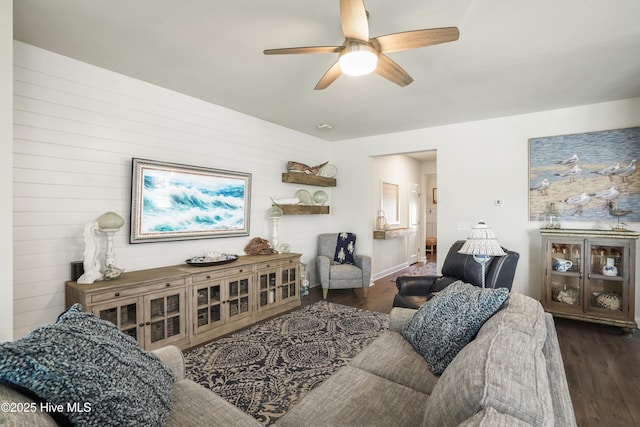 living room with ceiling fan and dark hardwood / wood-style flooring