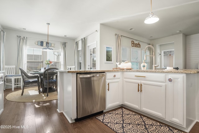 kitchen with dishwasher, dark hardwood / wood-style floors, light stone counters, white cabinets, and decorative light fixtures