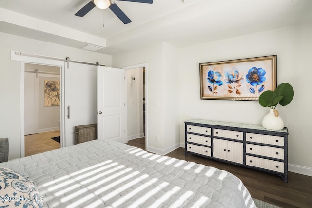 bedroom featuring a raised ceiling, a barn door, dark hardwood / wood-style floors, and ceiling fan