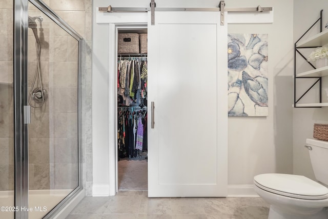 bathroom featuring an enclosed shower and toilet