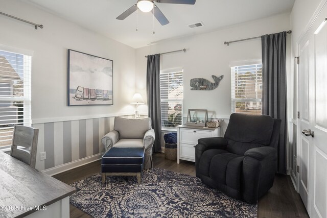 sitting room with ceiling fan and dark hardwood / wood-style flooring