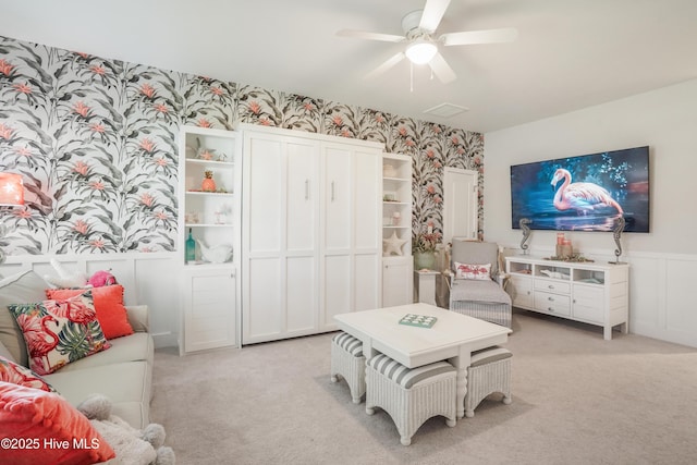 interior space featuring light colored carpet and ceiling fan