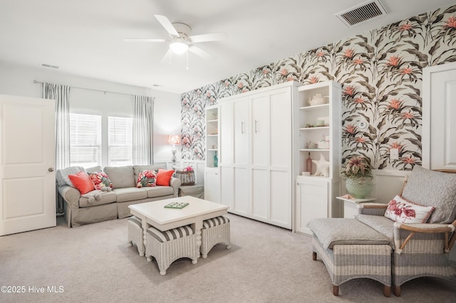 carpeted living room with ceiling fan