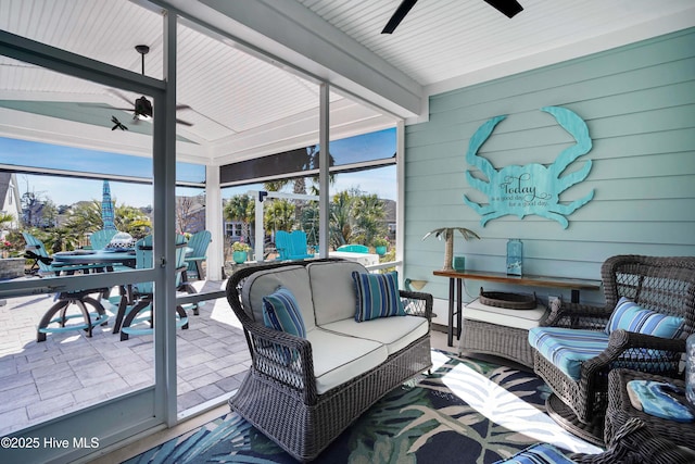 sunroom / solarium featuring vaulted ceiling with beams and ceiling fan