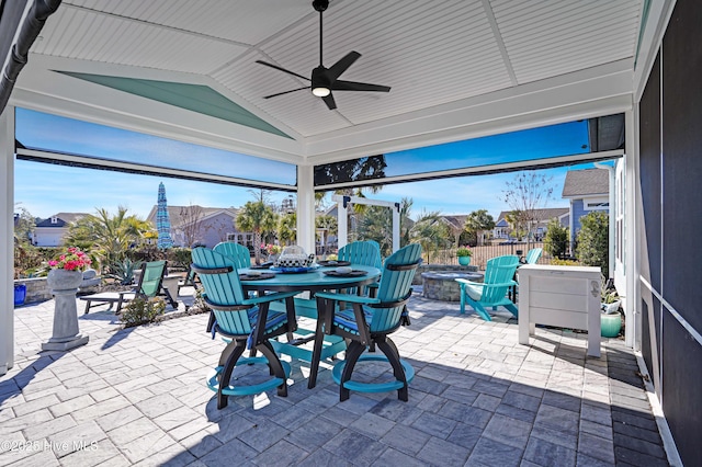 view of patio / terrace featuring ceiling fan and a fire pit