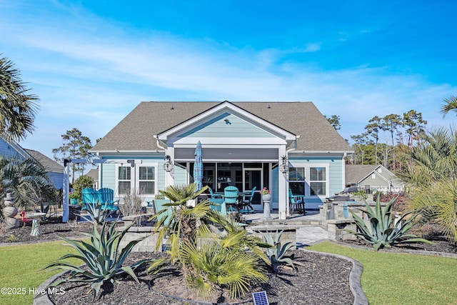 rear view of house featuring a yard and a patio area