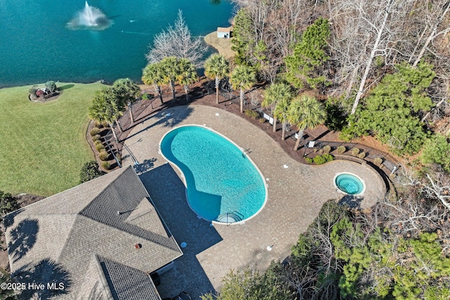 view of swimming pool with a water view and a yard