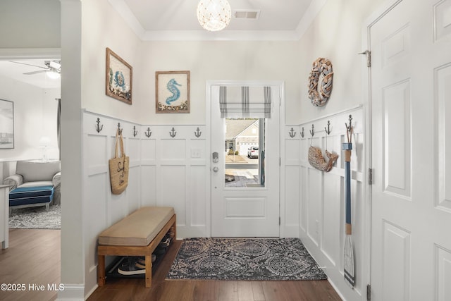 mudroom with crown molding, ceiling fan with notable chandelier, and dark hardwood / wood-style flooring