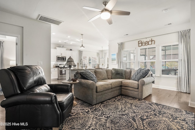 living room featuring hardwood / wood-style flooring and ceiling fan