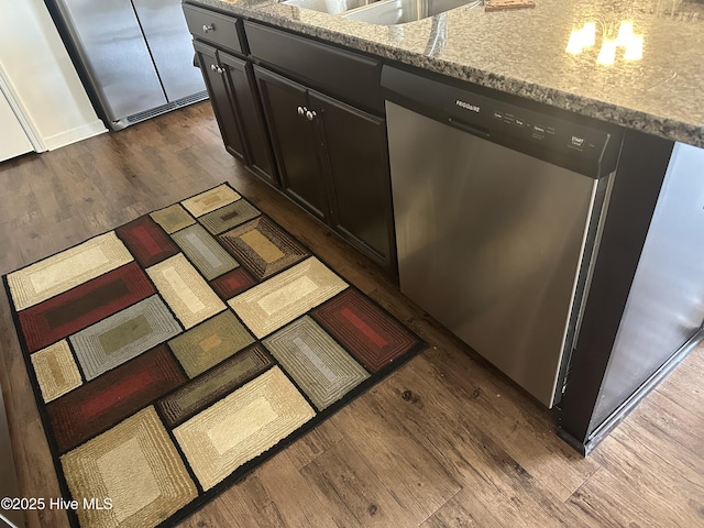 details with light stone counters, dark hardwood / wood-style floors, and dishwasher