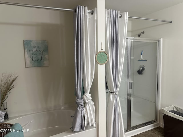 bathroom featuring separate shower and tub