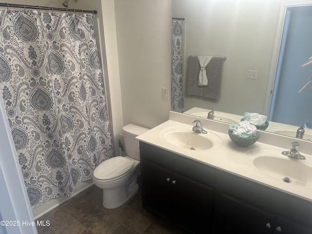 bathroom with vanity, walk in shower, and toilet