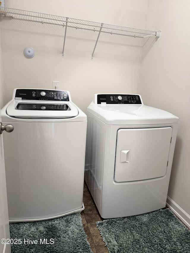 clothes washing area with washing machine and clothes dryer