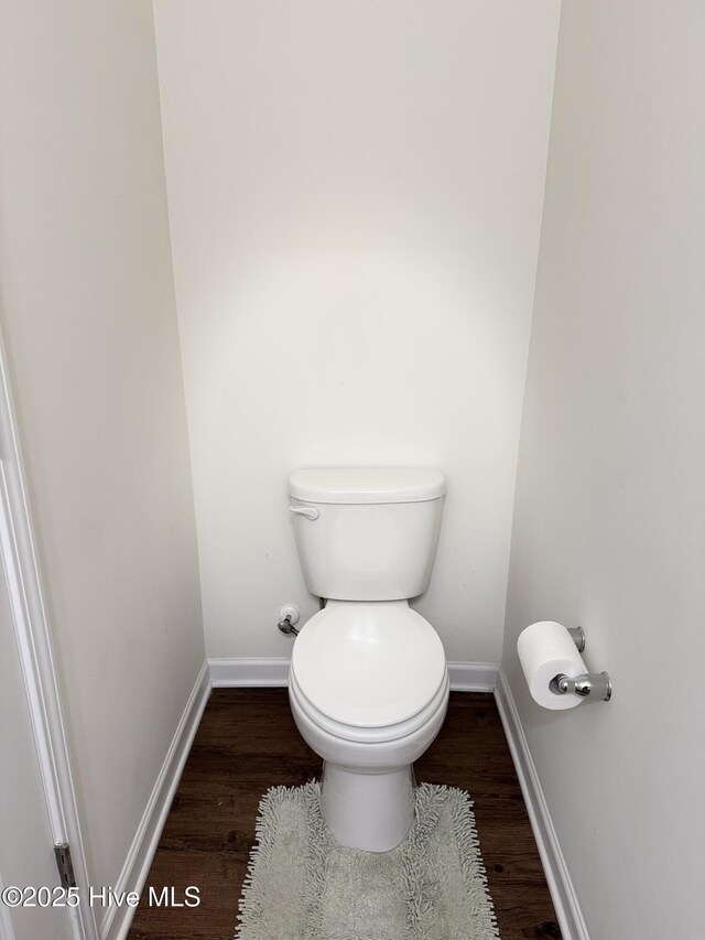 bathroom featuring hardwood / wood-style flooring and toilet