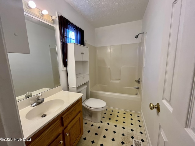 full bathroom featuring vanity, tub / shower combination, toilet, and a textured ceiling