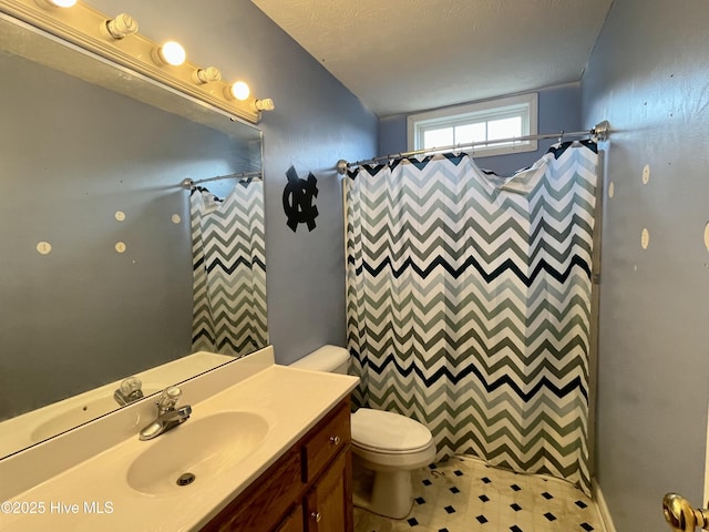 bathroom with vanity, curtained shower, and toilet