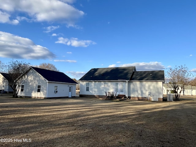 rear view of house featuring a yard