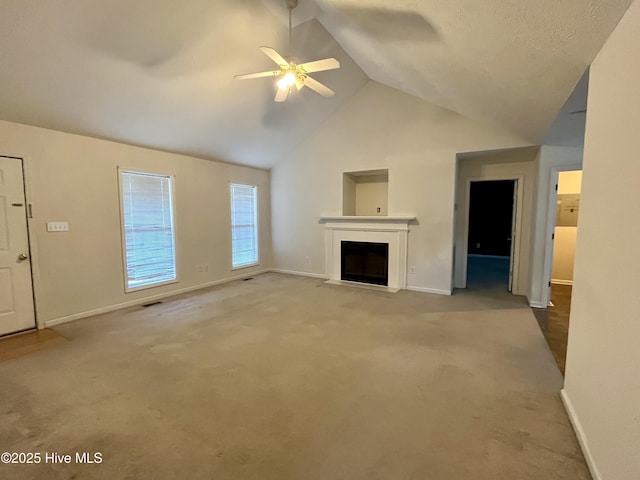 unfurnished living room featuring ceiling fan, high vaulted ceiling, and carpet floors