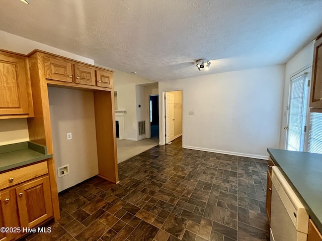 kitchen with a textured ceiling and dishwasher