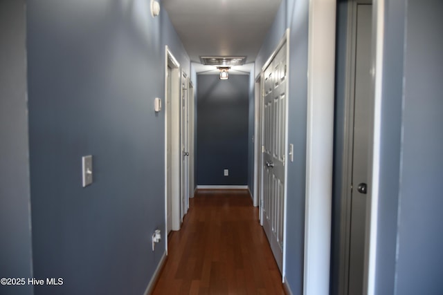 corridor with dark hardwood / wood-style floors