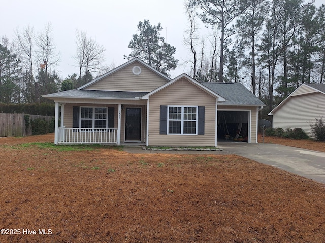 ranch-style home featuring a garage, covered porch, and a front yard