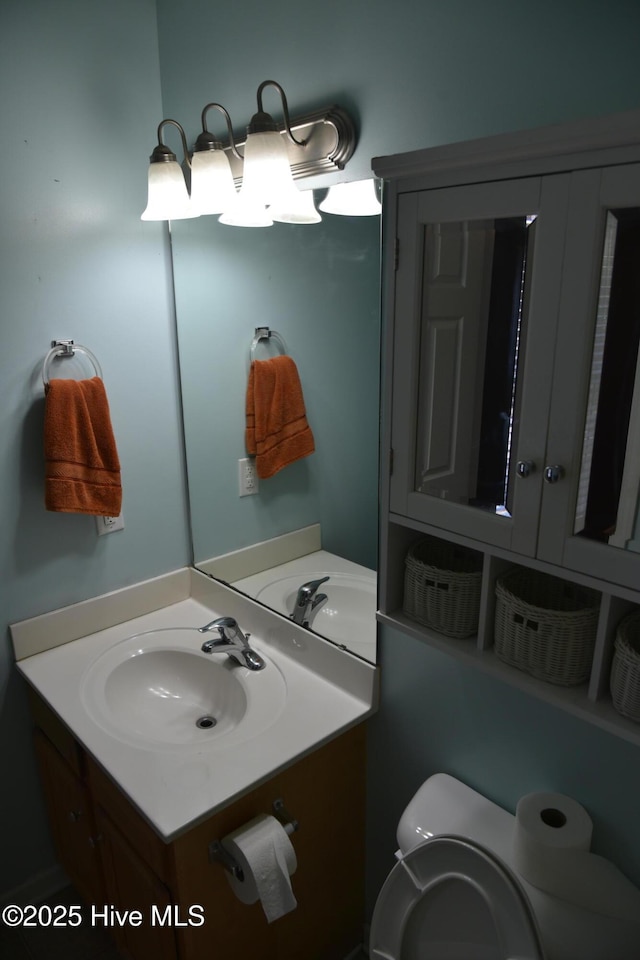 bathroom featuring vanity and toilet