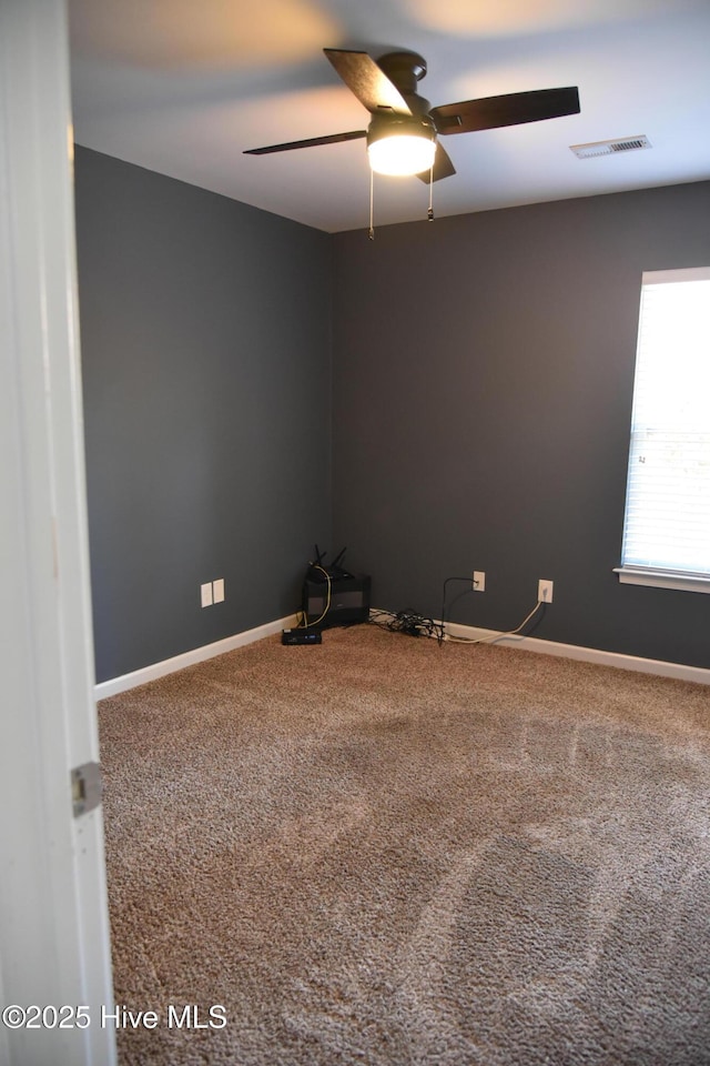 unfurnished room with ceiling fan and carpet floors