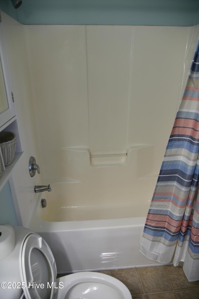 bathroom with tile patterned flooring, toilet, and shower / bath combo