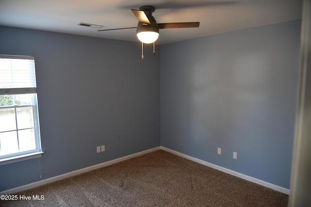 empty room with plenty of natural light, carpet floors, and ceiling fan