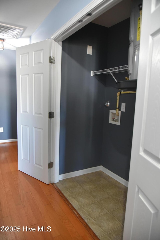 washroom with washer hookup and wood-type flooring